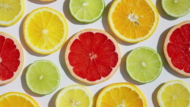 Sliced fresh citrus fruits grapefruit, orange, lemon, lime, kiwi rotate turn isolated white background close up for your top view design. Healthy fruit. Summer fresh fruit snack concept. Vitamin C