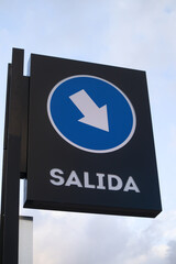 Closeup of a blue sign indicating the exit of a parking lot in a supermarket