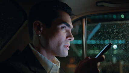 Serious director dictating phone message car closeup. Man using voice assistant