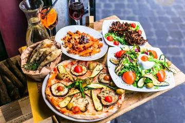 Gordijnen Travel in Italy, Part of Italian culture - healthy mediterranean italian food. Rome street restaurants with variety of typical pasta, pizza and salads © Freesurf