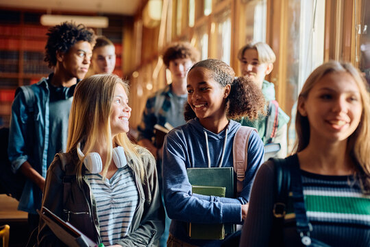 Multiracial Group Of Happy High School Students Talking After Class.