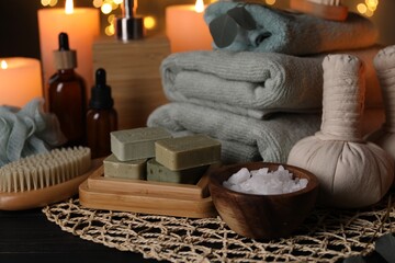 Beautiful composition with different spa products on table against blurred lights