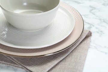 Clean plates, bowl and napkin on table, closeup
