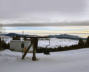 Sunrise in the mountains with old ski lift panorama. 