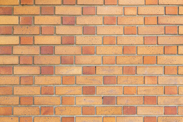 Pattern of a yellow and brown brick wall structure as background. High resolution texture of a yellow brick wall. Laying horizontal. Brick pattern looks natural, Urban Background, Close up, Copy space