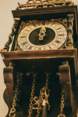 Antique clock on the wall with arrows pointing at midnight. Symbol of time - 718219557