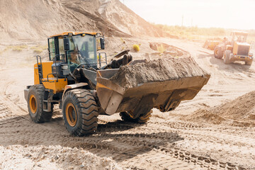 Open pit mine industry quarry, Yellow excavator working transporting sand