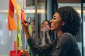 A dynamic female professional happily engaging in a creative brainstorming session with colorful sticky notes on a glass wall