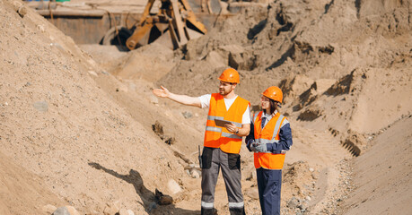 Sand quarry factory, Team Industrial workers engineers use computer tablet for control belt of...
