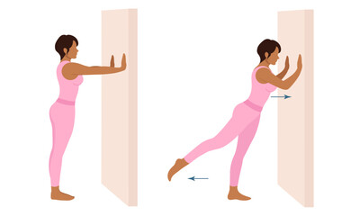 A woman does exercises near the wall. Wall Pilates.