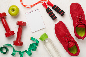 Sport equipment with tape measure on concrete background, top, view