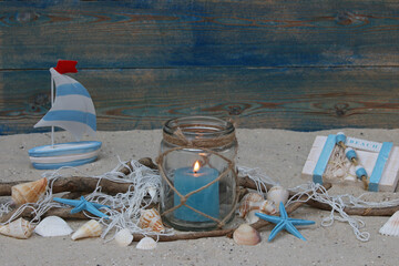Maritime decoration with lantern, starfish and seashells in the sand. Space for text. - obrazy, fototapety, plakaty
