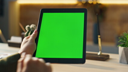 Unknown businesswoman using chromakey tablet for internet surfing office closeup