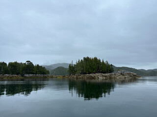 Fototapeta na wymiar Scenic view of several islands along the Central Coast of British Columbia on an overcast and moody day. Near Stryker Island, British Columbia, Canada
