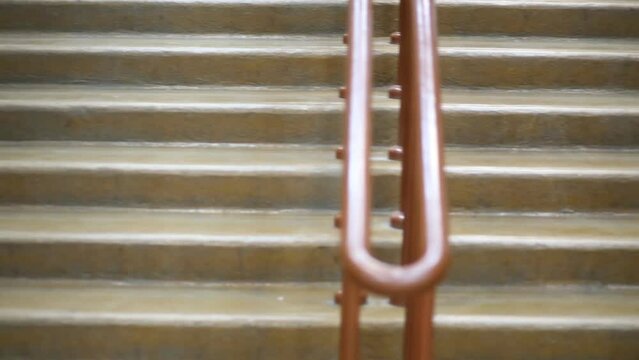 Woman in white dress walking down stairs, then next man.