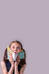 A young pretty happy girl holding Euro money in her hands. Copy space. Vertical image.