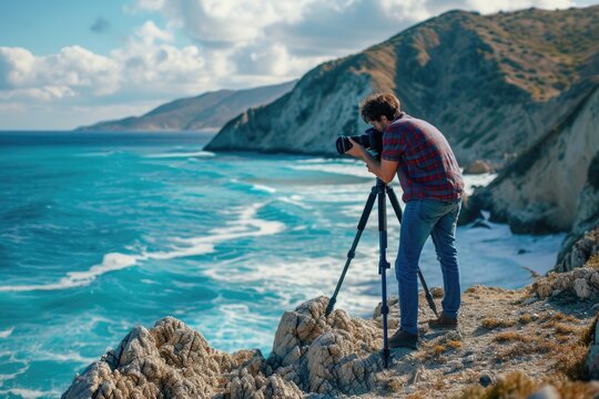 A man is seen taking a picture of the vast ocean. This image can be used to depict travel, photography, or nature exploration