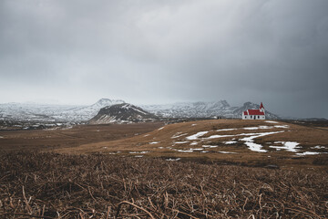 Red church in snowy mountain landscape, Iceland