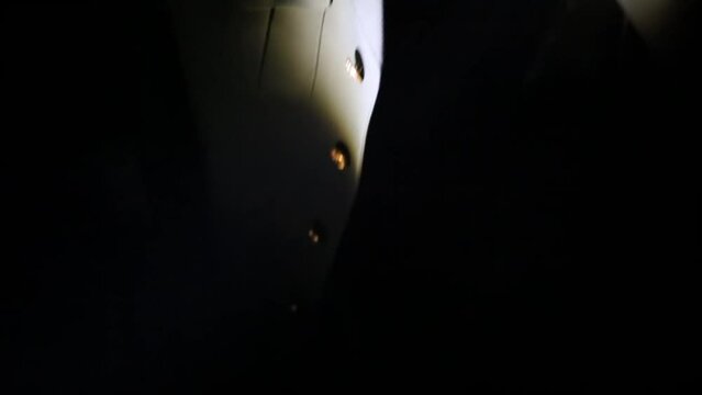 Lantern light beam buttoned military jacket on chair in dark on quest.