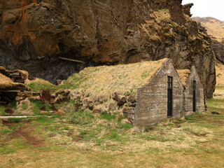 Drangurinn í Drangshlíð is a characteristic tuff rock formation that stands alone on the grazing land of Drangshlíð farm