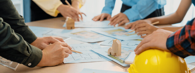 Professional architect team and engineer discuss about architectural project on meeting table with...
