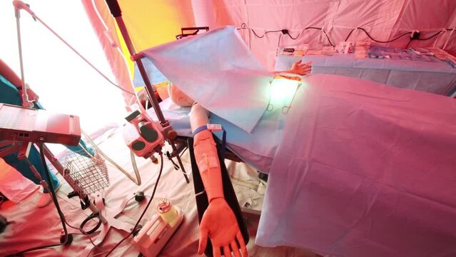 Mannequin lying on the operating table in tent in mobile hospital