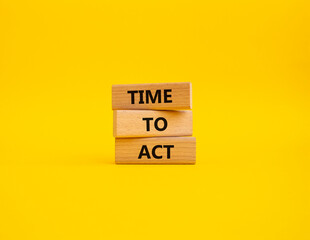 Time to Act symbol. Wooden blocks with words Time to Act. Beautiful yellow background. Business and...