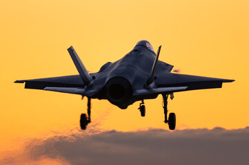 Fototapeta premium A Lockheed Martin F-35 Lightning II fifth generation fighter jet is ready to land during a beautiful sunset.