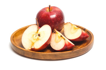 Half cut sliced and two whole fresh organic red apple delicious fruit in a wooden plate isolated on white background clipping path