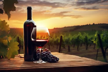 Fotobehang Red wine and bottle on wooden table with grape vines on blurred sunset vineyard landscape. Production at winery. Generative AI © Aradia