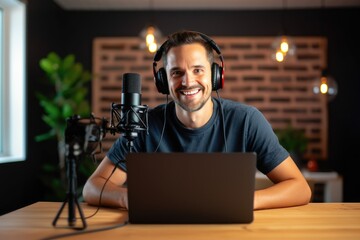 A cheerful male podcaster records an episode in a professional studio setup, radiating positivity and engagement.