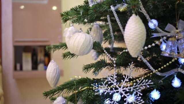 Close up view of artificial christmas tree with decoration is standing