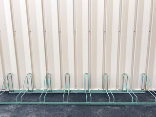 Bicycle racks in front of a metal wall - 718276102