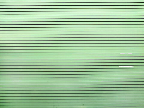 Green wall with horizontal planks