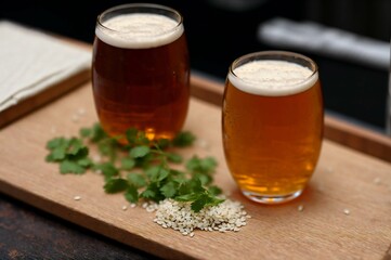 Glass of beer with steamed rice and parsley on wooden board