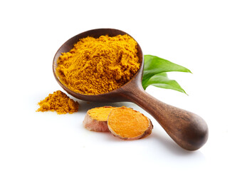 Turmeric powder with slices in closeup on white background