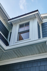Bay Window Detail on Blue and Gray Sided Home, Upward View