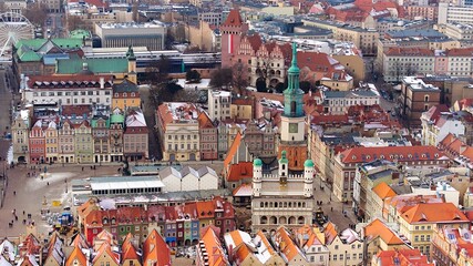 Aerial view of Poznan's historic market square in winter, showcasing the charming old townhouses...