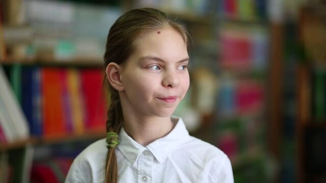 Girl with pigtail looking to front and to side in the library