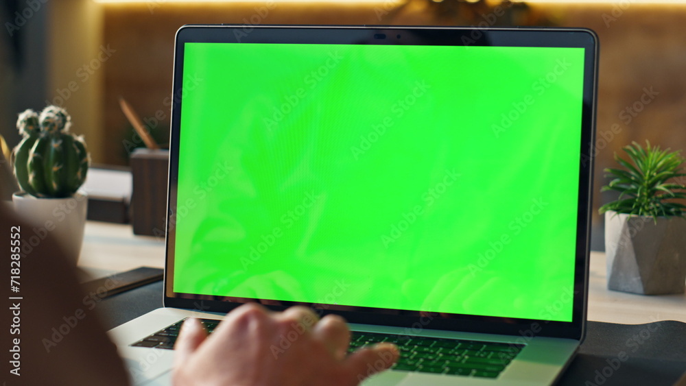 Wall mural unrecognizable person using mockup laptop working remotely at home close up.