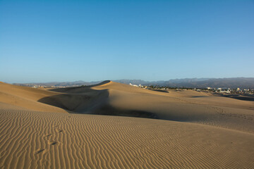 Sand dunes of Maspalomas with a view of the city on Gran Canaria, Spain