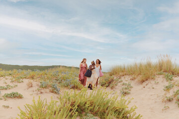 multiracial group of three young women enjoying a summer day at the beach. Traveling with friends.