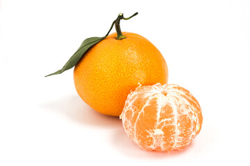 Peeled and whole fresh organic orange delicious fruit side view with green leaves isolated on white background clipping path