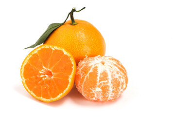 Half cut peeled and whole fresh organic orange delicious fruit side view with green leaves isolated on white background clipping path