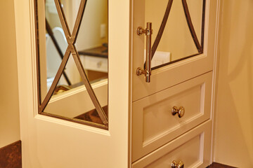 Elegant Cream Cabinet with Mirrored Doors and X-Pattern Detail