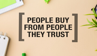 PEOPLE BUY FROM PEOPLE THEY TRUST - text on notepad on yellow desk.