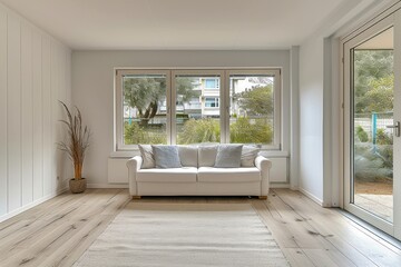 a living room with white walls and a window