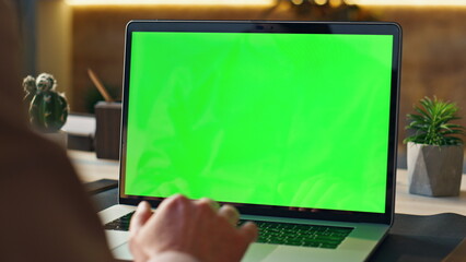 Worker scrolling touchpad green screen laptop at office workplace close up.