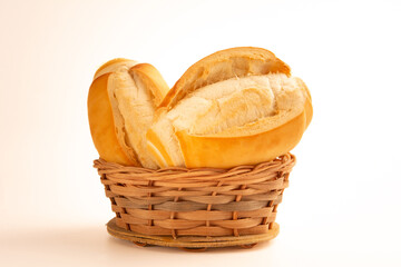 Fresh baked flour bread inside a bamboo basket in a white clean background in front view photo