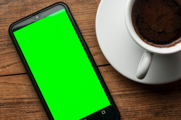 Cup Coffee and Smart phone on wooden table